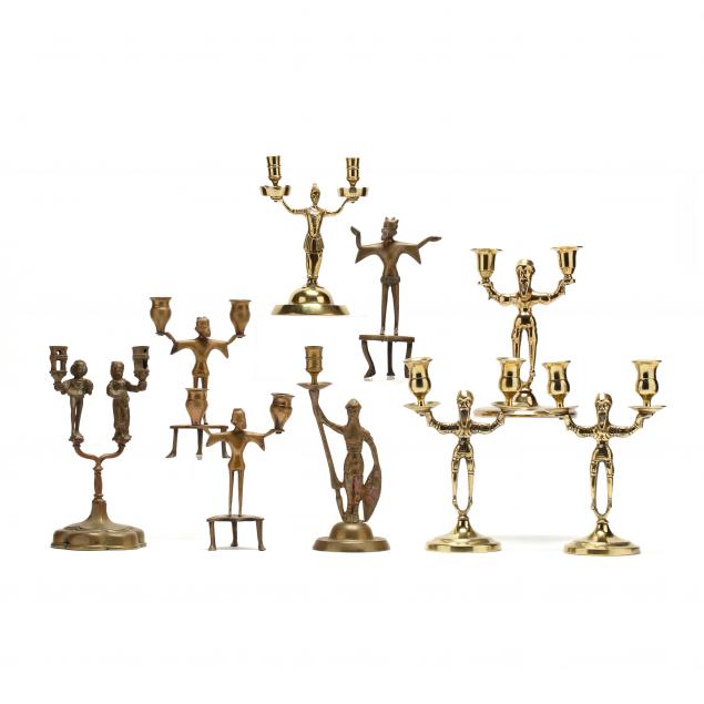 nine-antique-figural-brass-candlesticks