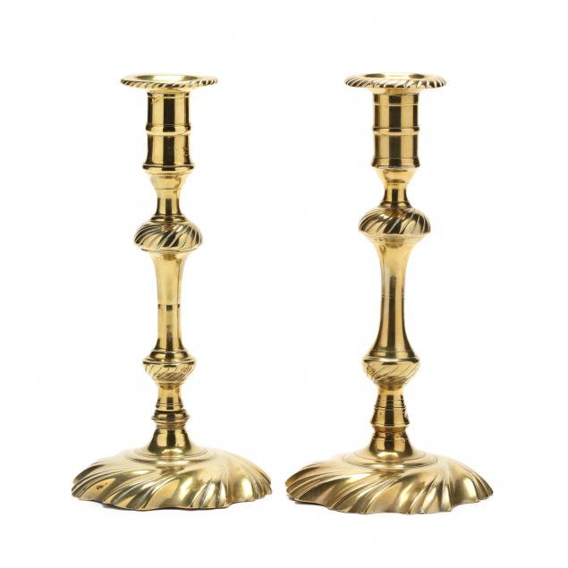 a-near-pair-of-spiral-decorated-queen-anne-brass-candlesticks