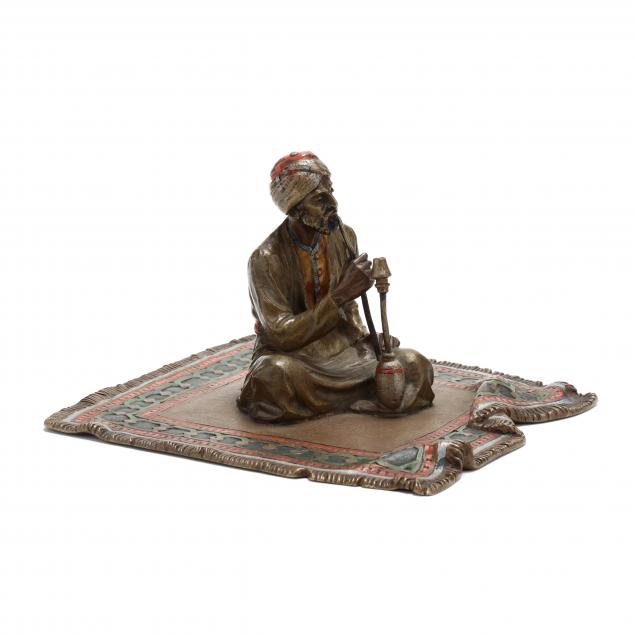 an-austrian-cold-painted-bronze-figure-of-a-seated-figure