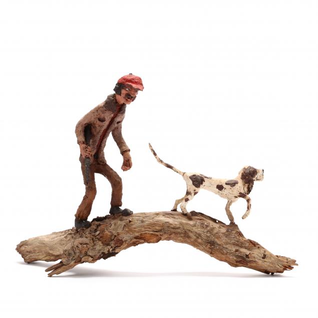 a-vintage-folk-art-sculpture-of-a-hunter-and-hound-dog
