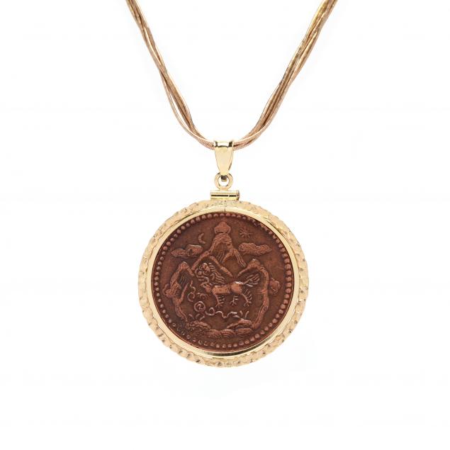 a-gold-multi-strand-necklace-and-a-copper-pendant