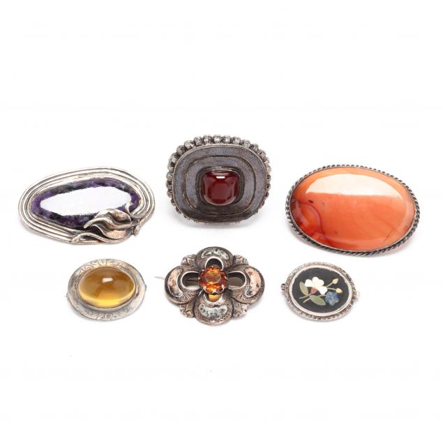 six-silver-and-gem-set-brooches