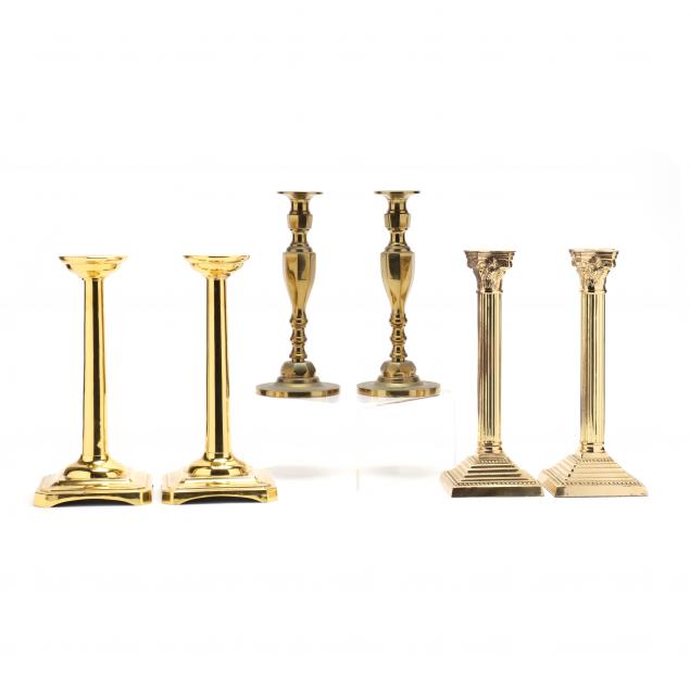 three-pairs-of-decorative-brass-candlesticks