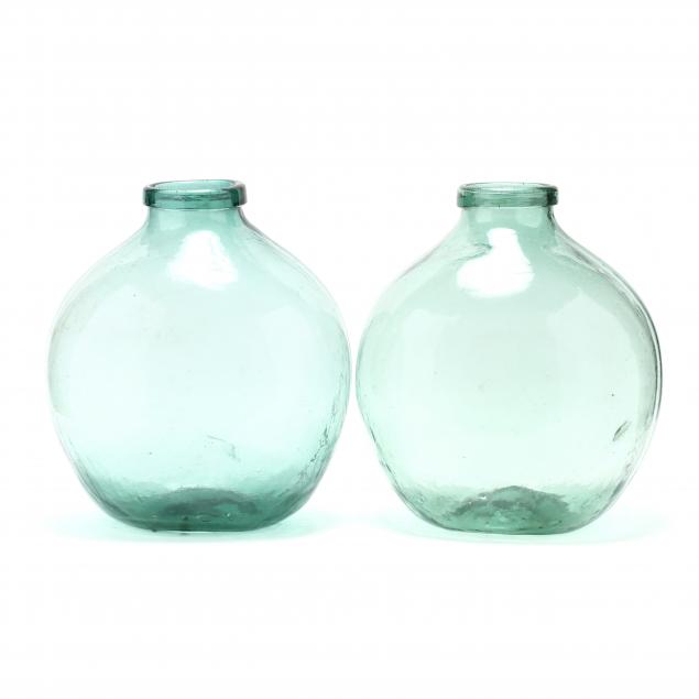 two-large-green-demijohn-bottles