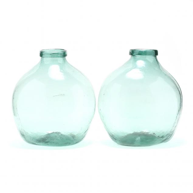 two-large-green-glass-demijohn-bottles