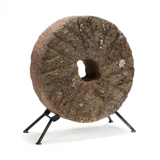 a-small-antique-millstone-with-stand