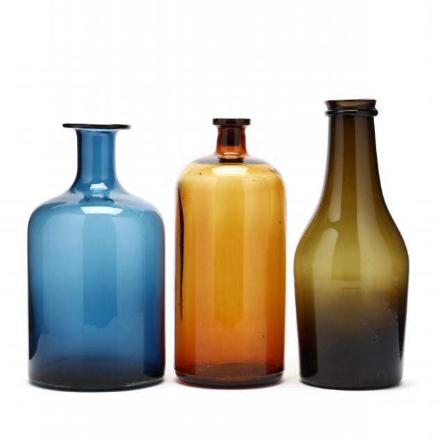 three-large-and-colorful-glass-bottles