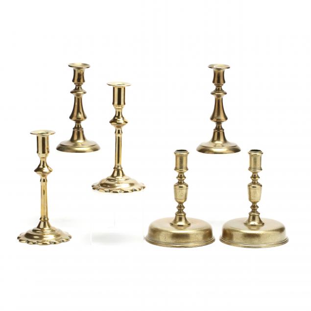 three-pair-of-antique-brass-candlesticks