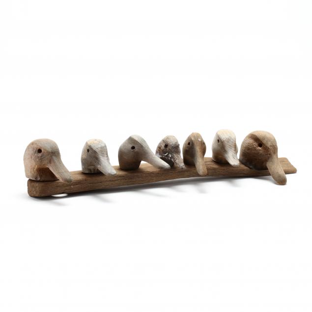 seven-mounted-wooden-decoy-heads-arrangement-by-bob-timberlake