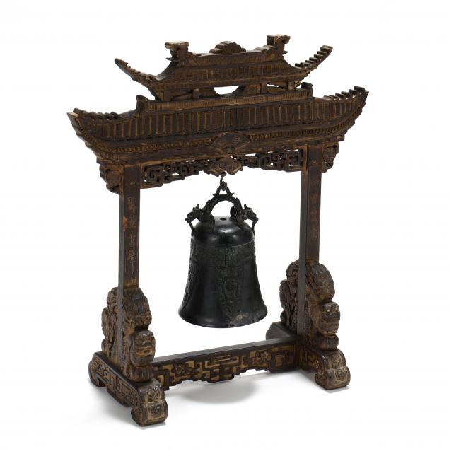 an-asian-bronze-bell-and-carved-wooden-temple-gate-stand