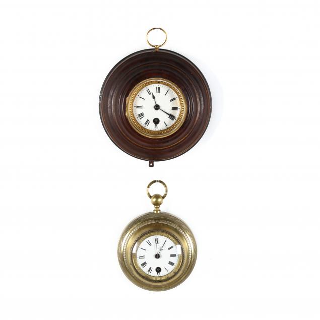 two-small-round-wall-clocks