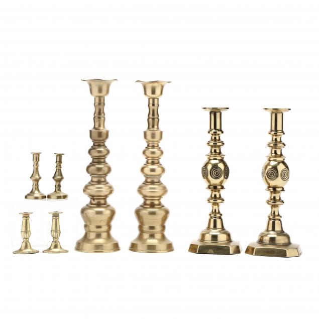 two-pairs-of-tall-brass-candlesticks-and-two-pairs-of-small-candlesticks