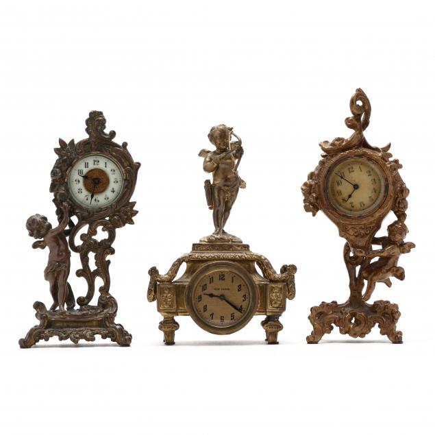 three-antique-figural-desk-clocks