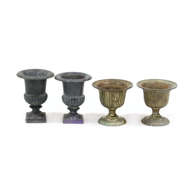 four-small-cast-metal-urns