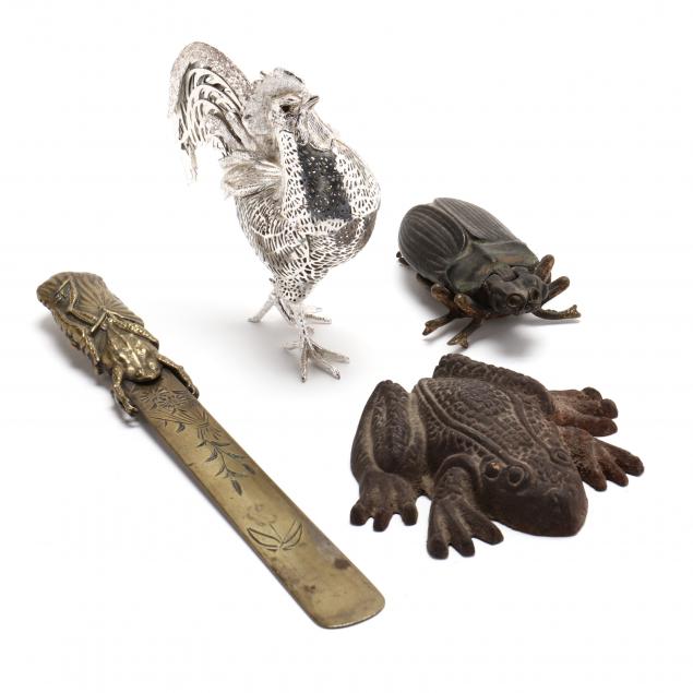 a-grouping-of-four-metal-animal-accessories
