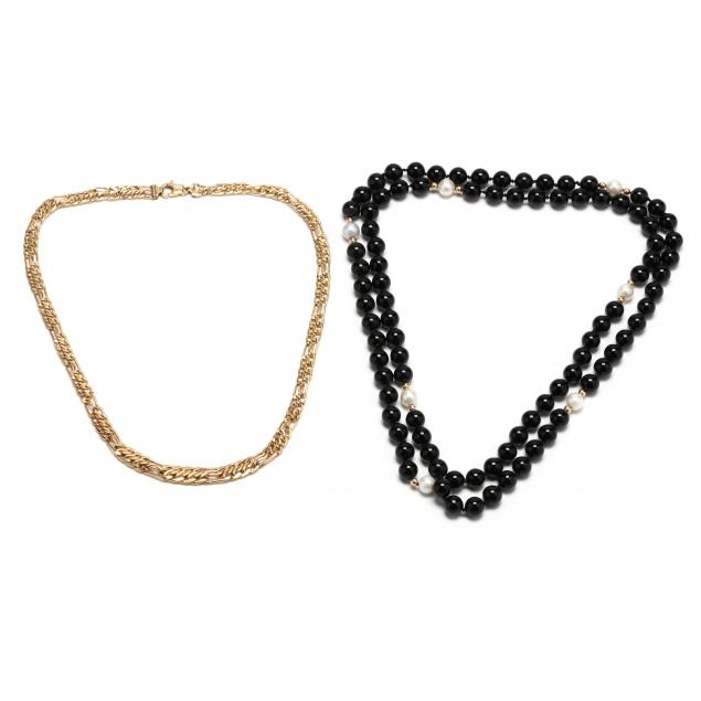 a-gold-necklace-and-an-onyx-and-pearl-necklace