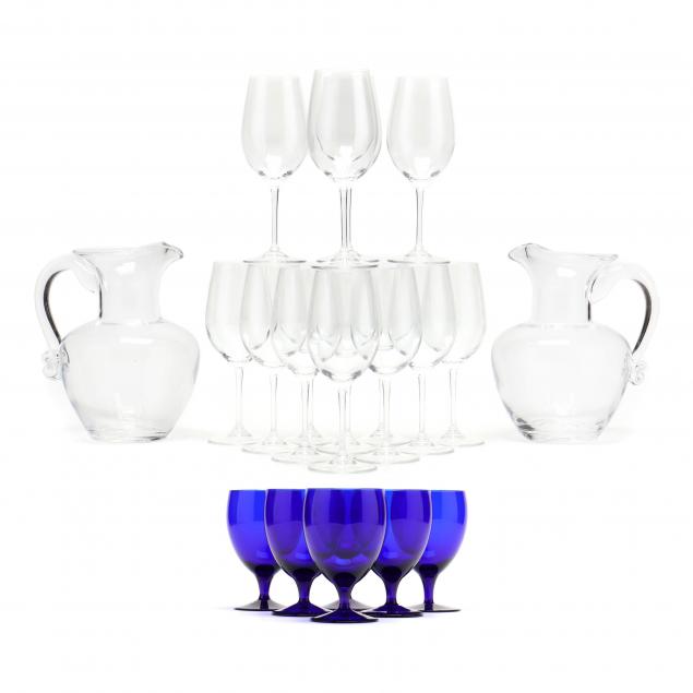 a-pair-of-simon-pearce-glass-pitchers-and-assorted-stemware