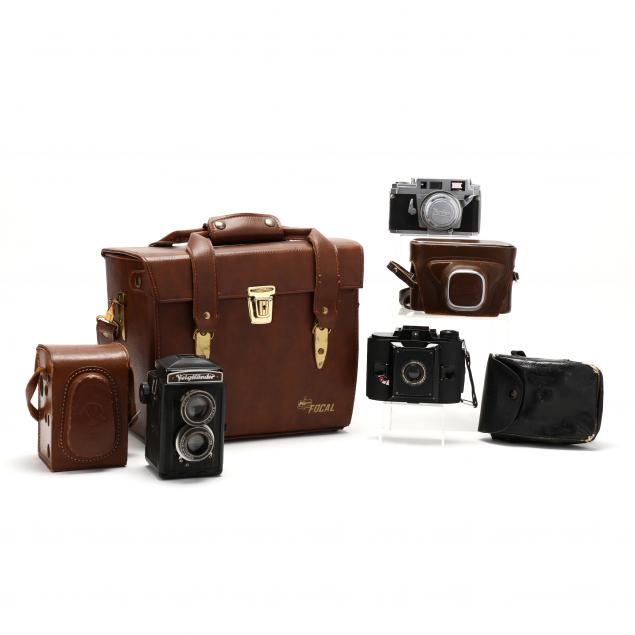three-vintage-cameras-and-accessories