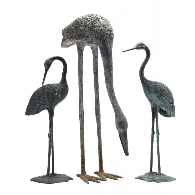 three-cast-and-painted-metal-cranes