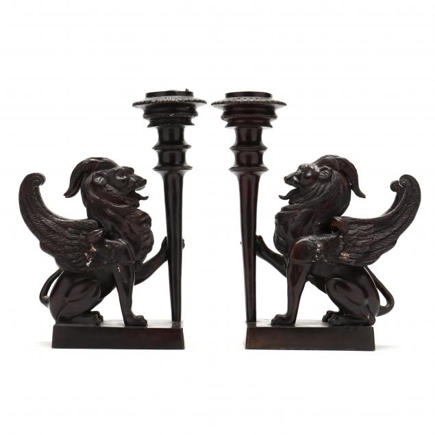 pair-of-bronze-candlesticks-held-by-mythical-creatures