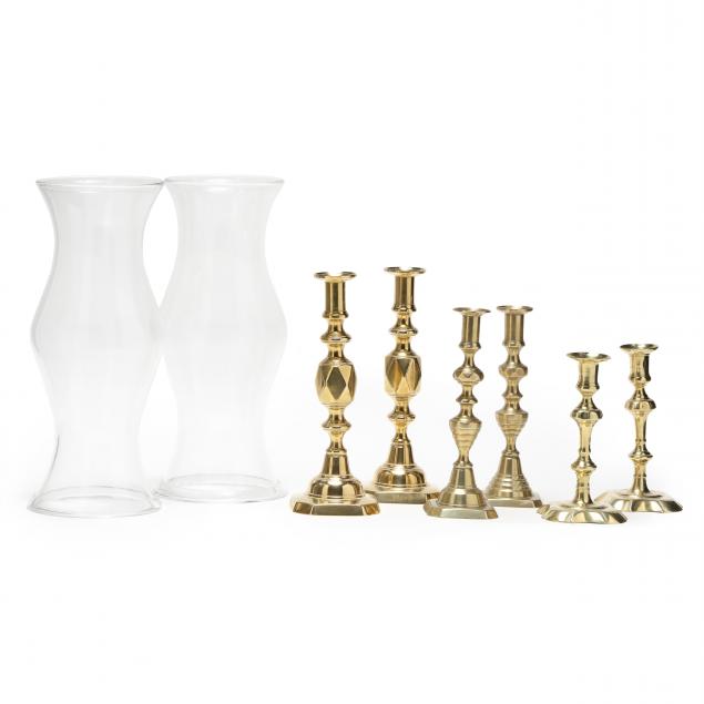 three-pair-of-antique-brass-candlesticks-and-a-pair-of-hurricane-shades