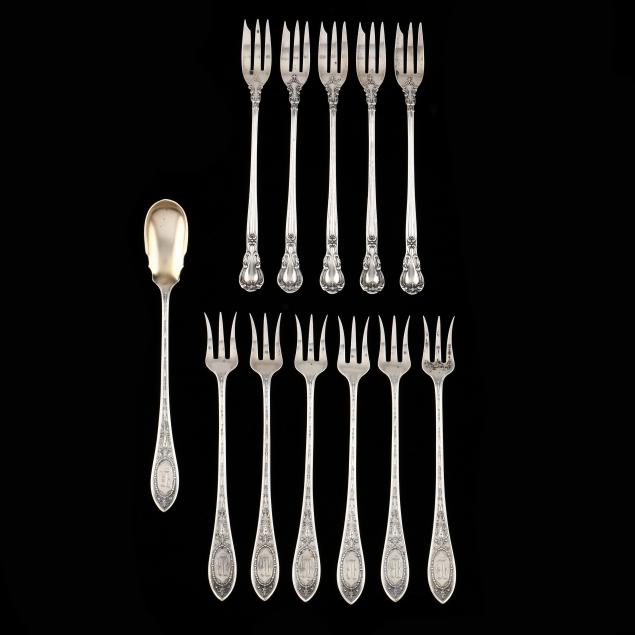 an-assembled-set-of-sterling-silver-cocktail-forks-and-an-olive-server