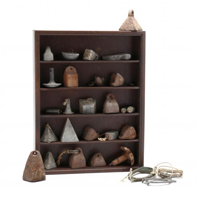 collection-of-iron-gunning-weights-with-display-shelf