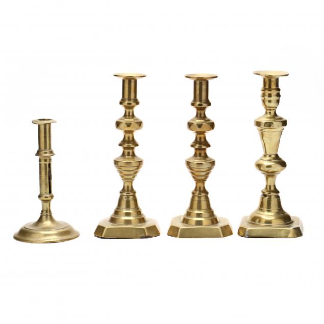 four-antique-brass-candlesticks