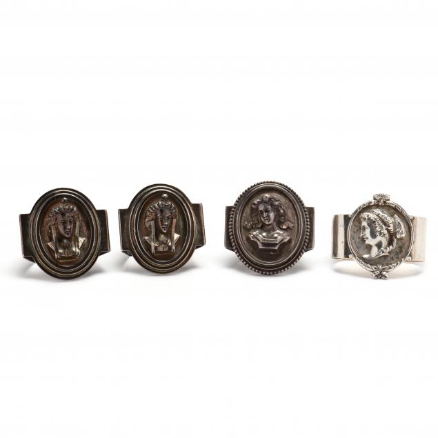 an-assembled-set-of-four-sterling-silver-and-coin-silver-medallion-napkin-rings