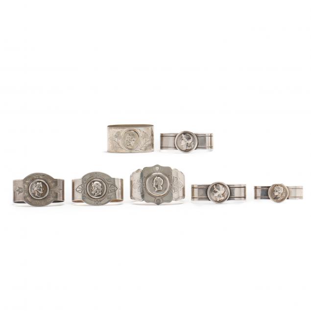 an-assembled-set-of-six-silver-medallion-napkin-rings