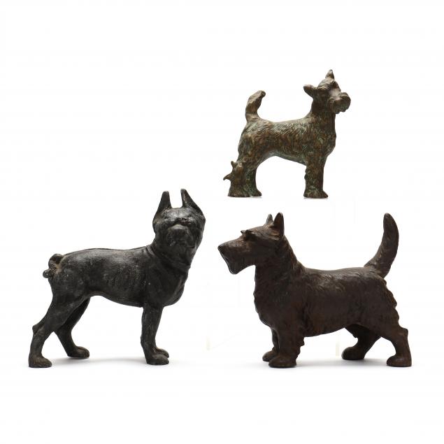 three-vintage-cast-metal-dog-doorstops