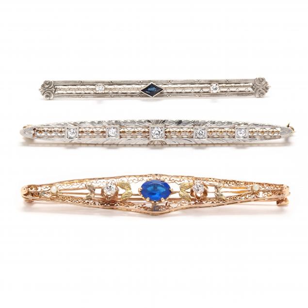 three-gold-and-gem-set-bar-brooches