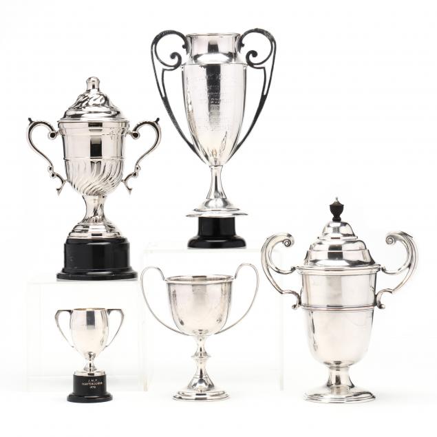 a-grouping-of-five-silverplate-trophies