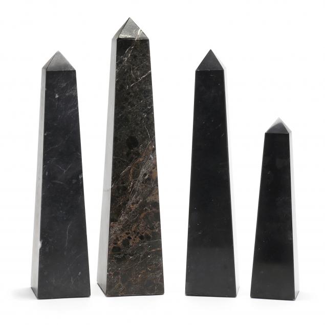 a-grouping-of-four-large-black-marble-obelisks