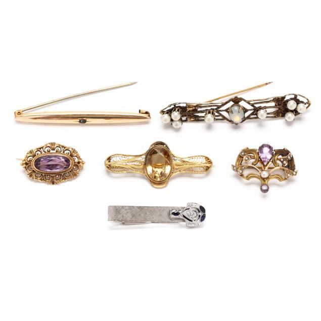 five-gold-and-gem-set-brooches-and-a-white-gold-and-gem-set-tie-clip