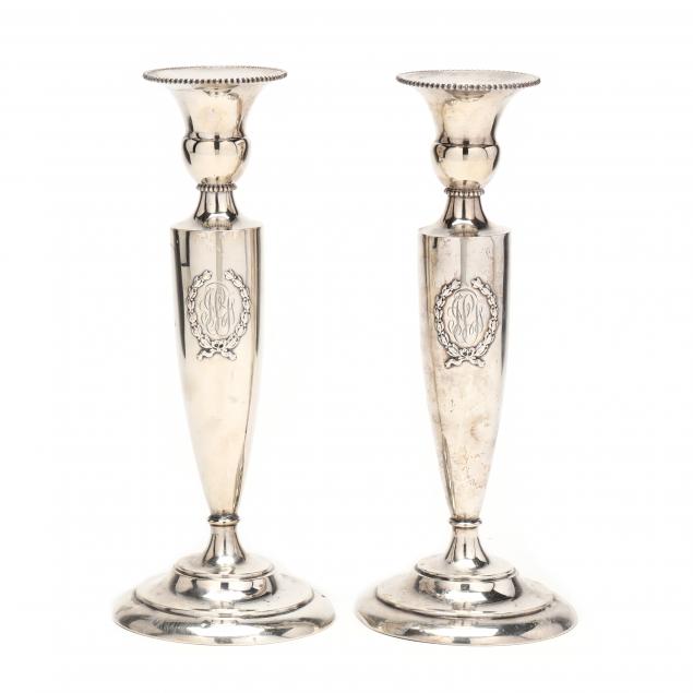 a-pair-of-sterling-silver-candlesticks