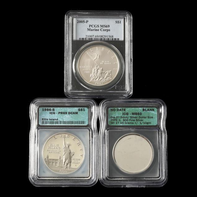 two-graded-commemorative-silver-dollars-and-a-blank-silver-planchet