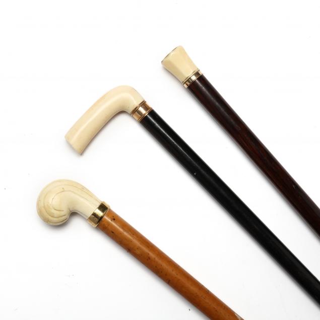 three-antique-ivory-and-gold-handled-walking-sticks
