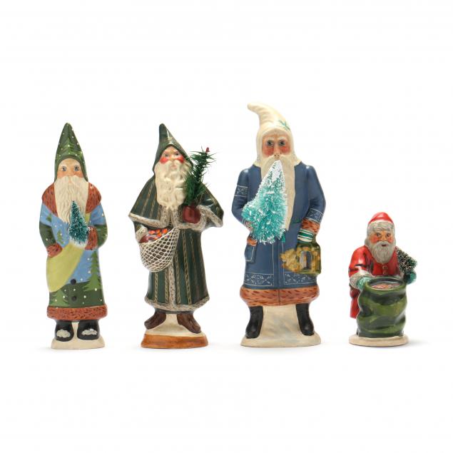 four-vaillancourt-santa-figures-each-with-brush-tree