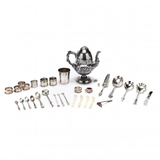 a-grouping-of-assorted-silverplate-flatware-and-holloware