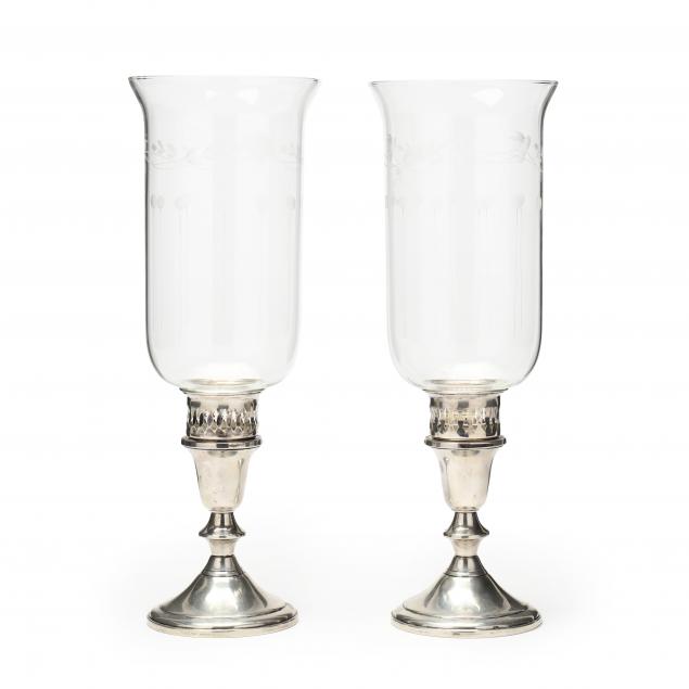 a-pair-of-sterling-silver-candlesticks-with-glass-hurricane-shades