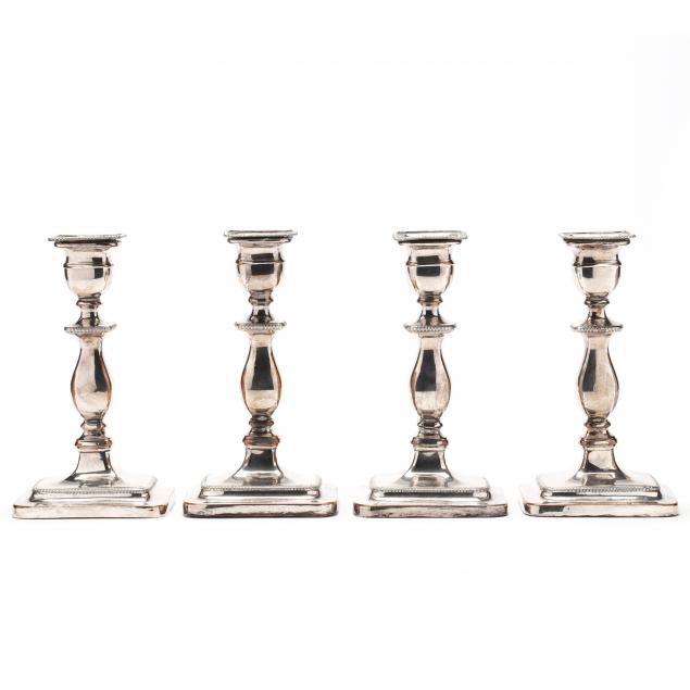 a-set-of-four-english-silverplate-candlesticks
