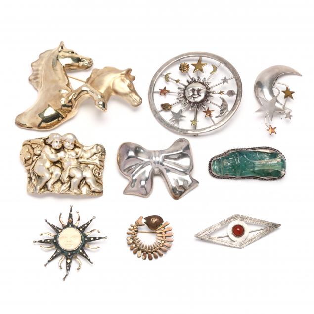 group-of-silver-brooches