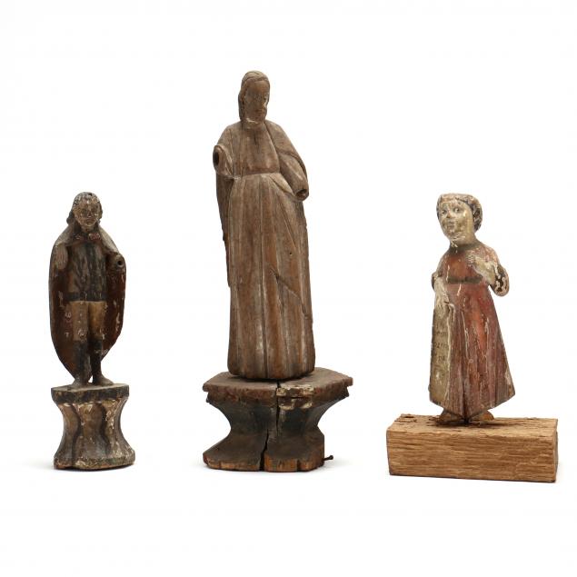 three-antique-carved-and-polychrome-santos-figures