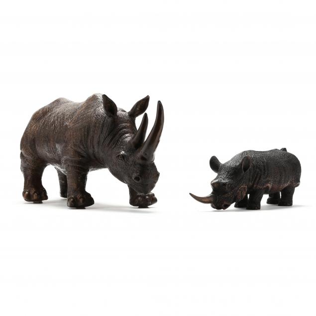 two-sculptures-of-a-rhinoceros-rendered-in-bronze-and-wood