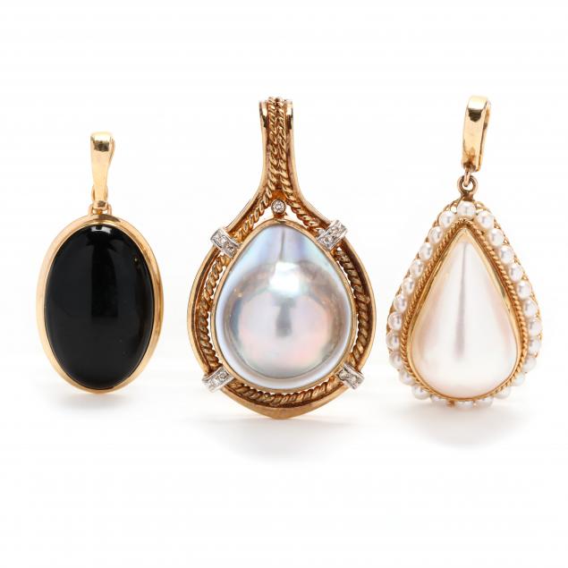 three-gold-and-gem-set-pendants