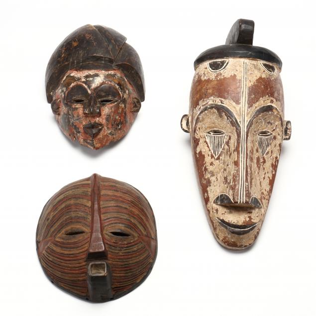 three-west-african-carved-and-painted-wooden-masks