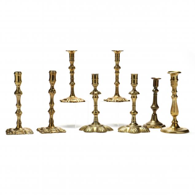 a-grouping-of-eight-antique-english-brass-candlesticks