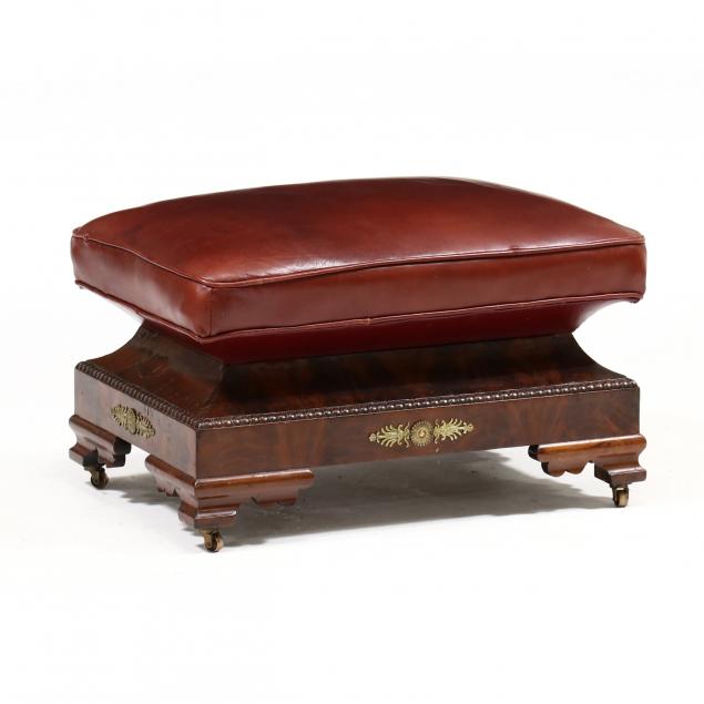 a-large-american-classical-leather-and-mahogany-ottoman