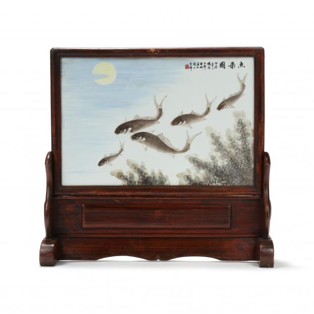 a-chinese-porcelain-plaque-of-fish-set-into-carved-wooden-stand